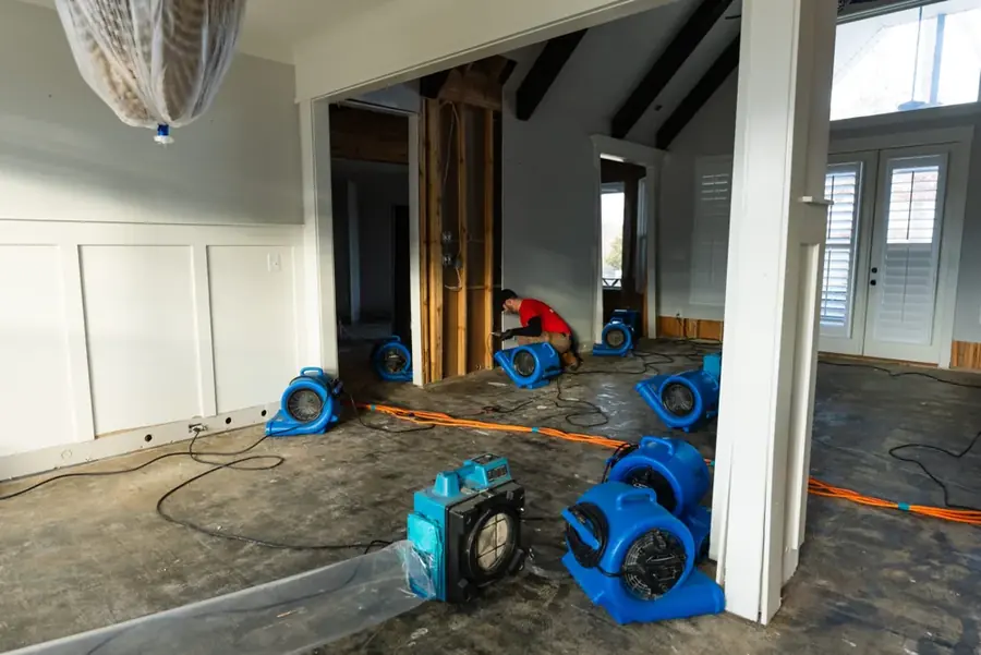 Restoration crew drying a water damaged Smyrna, GA home with air movers
