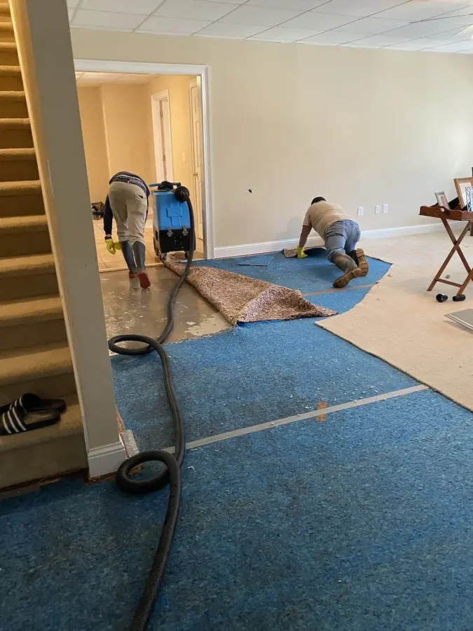 Flooded basement being pumped and dried in a Smyrna, GA home